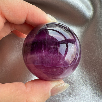 Purple Fluorite Sphere 紫紅螢石球  螢石是不可或缺的晶石之一，除左螢石有豐富嘅色彩和好高的觀賞價值之外，放她在工作枱亦都可以時時刻刻緩解煩躁的情緒，有助減低壓力，去除人體積累的負能量，同時亦可以減低電子器材發出的輻射。  -螢石  -幫助頭腦保持清晰  -提升注意力集中  -適合常常用腦ge 朋友同同學仔  紫螢石適合從事思考的工作者，讓思考更敏銳。