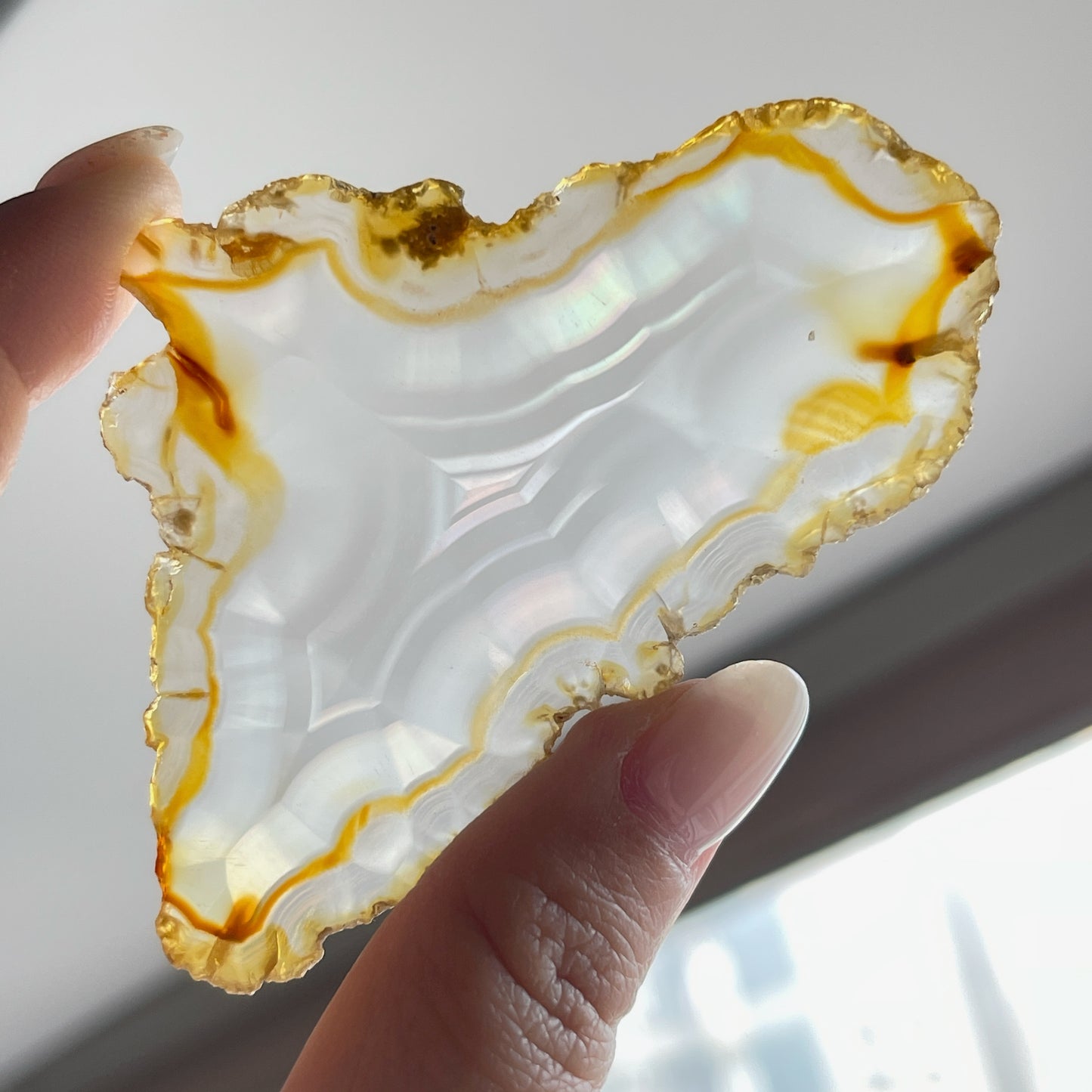 虹彩瑪瑙是一種細帶狀、半透明的石髓 (Chalcedony)，並且可將透射光分解成為光譜顏色。”Iris”意為”彩虹”或”虹彩虹色的”，源自於希臘彩虹女神的名字。  Iris agate is a finely-banded, translucent variety of chalcedony that breaks up transmitted light into spectral colors. The word “Iris” means “rainbow” or “to make iridescent” and is derived from the name of the Greek goddess of the rainbow.     *以上資料轉載自 “GIA Hong Kong - Jul 2021”