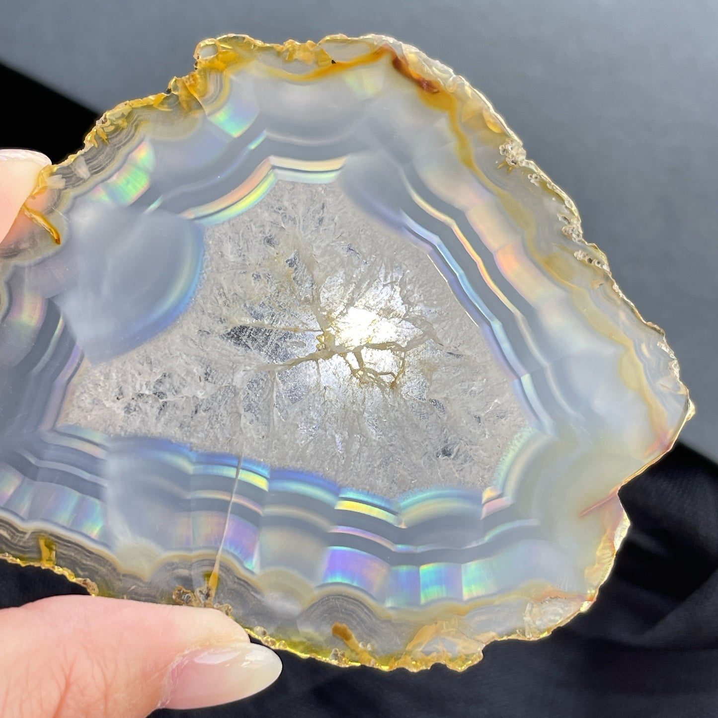 虹彩瑪瑙是一種細帶狀、半透明的石髓 (Chalcedony)，並且可將透射光分解成為光譜顏色。”Iris”意為”彩虹”或”虹彩虹色的”，源自於希臘彩虹女神的名字。  Iris agate is a finely-banded, translucent variety of chalcedony that breaks up transmitted light into spectral colors. The word “Iris” means “rainbow” or “to make iridescent” and is derived from the name of the Greek goddess of the rainbow.     *以上資料轉載自 “GIA Hong Kong - Jul 2021”